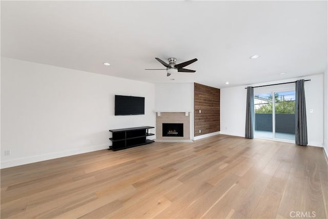 unfurnished living room with ceiling fan and light wood-type flooring