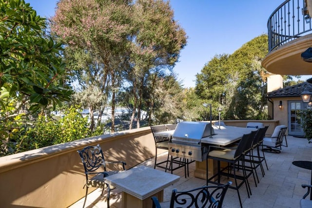 view of patio / terrace with a grill and a balcony