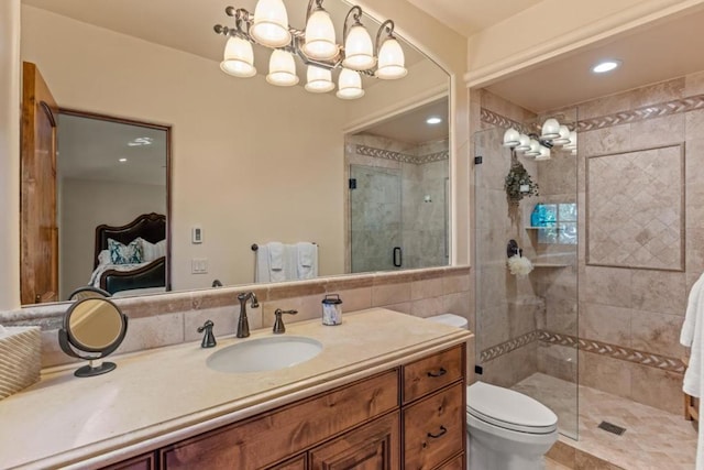 bathroom with vanity, a shower with shower door, and toilet