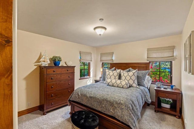 bedroom featuring light colored carpet