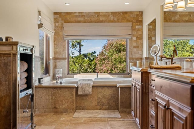 bathroom with a relaxing tiled tub and tile walls