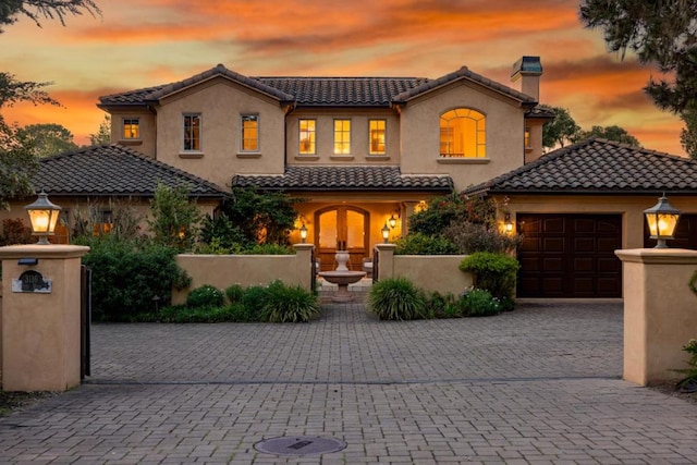 mediterranean / spanish house with a garage