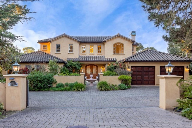 mediterranean / spanish house featuring a garage