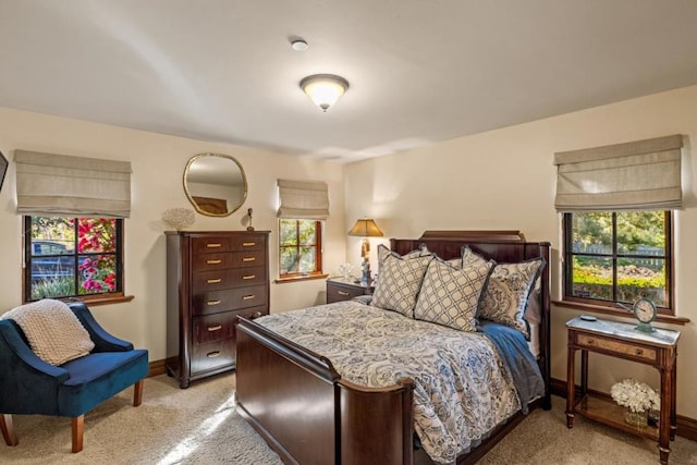 carpeted bedroom featuring multiple windows