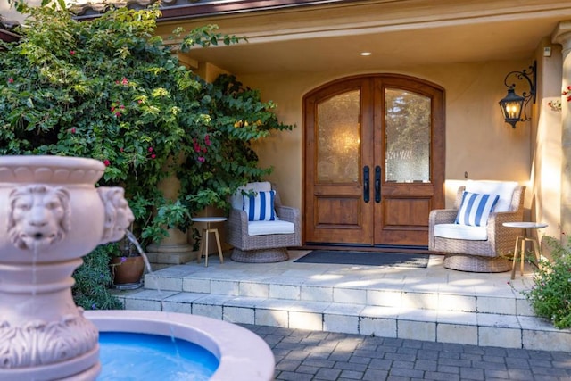 entrance to property featuring french doors and a patio