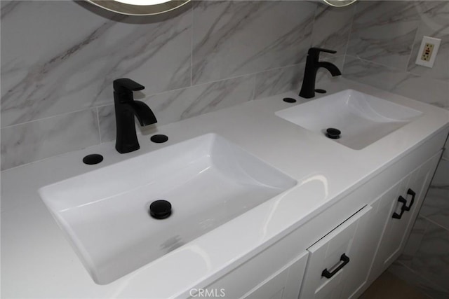 bathroom featuring vanity and backsplash