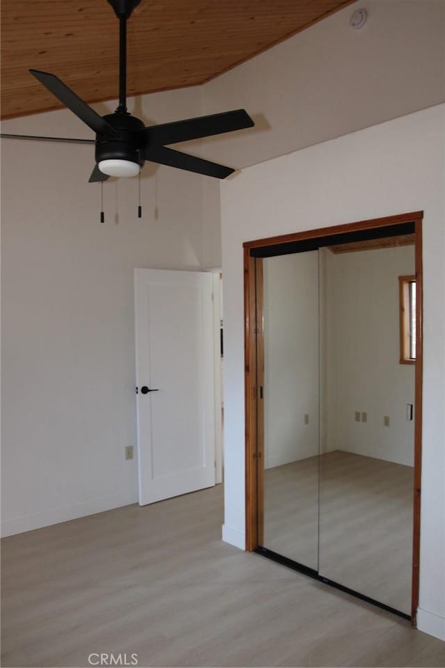 unfurnished bedroom featuring ceiling fan, a closet, and wood ceiling