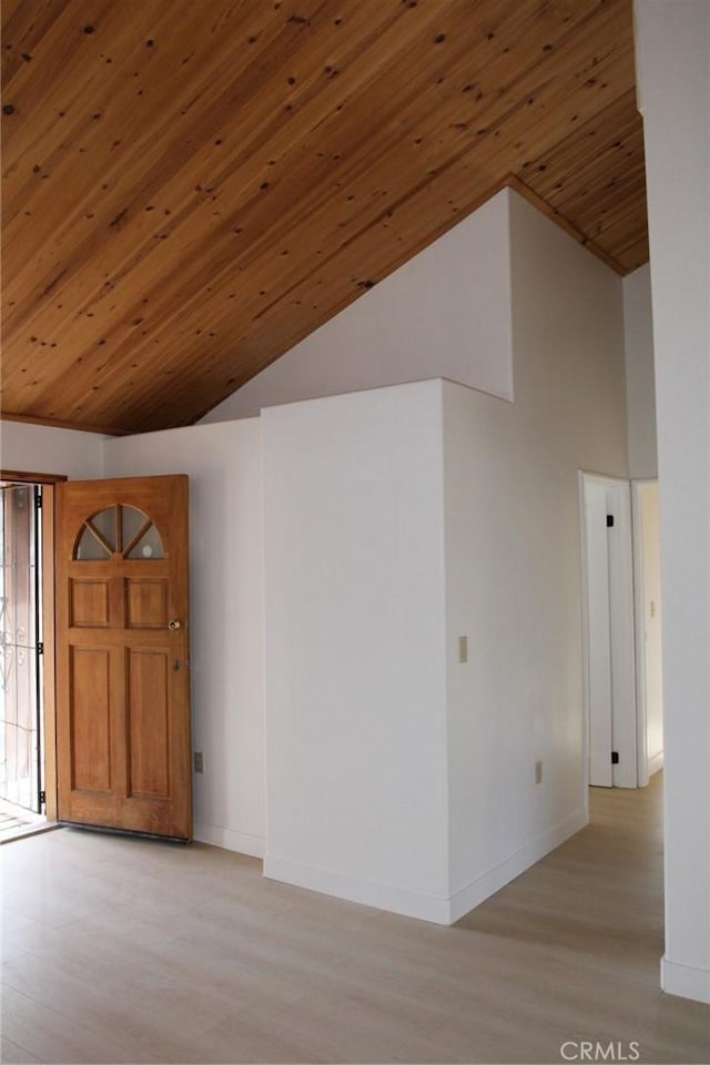 empty room featuring high vaulted ceiling and wood ceiling