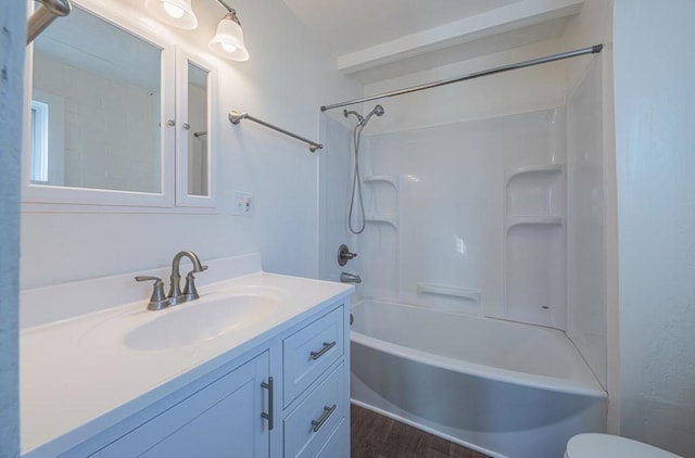 full bathroom with shower / tub combination, toilet, hardwood / wood-style flooring, and vanity