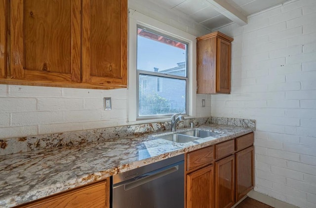 kitchen with sink, brick wall, dishwasher, and a healthy amount of sunlight