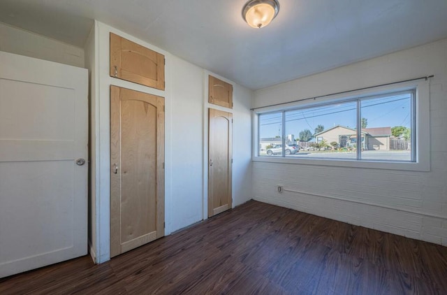 unfurnished bedroom featuring dark hardwood / wood-style flooring