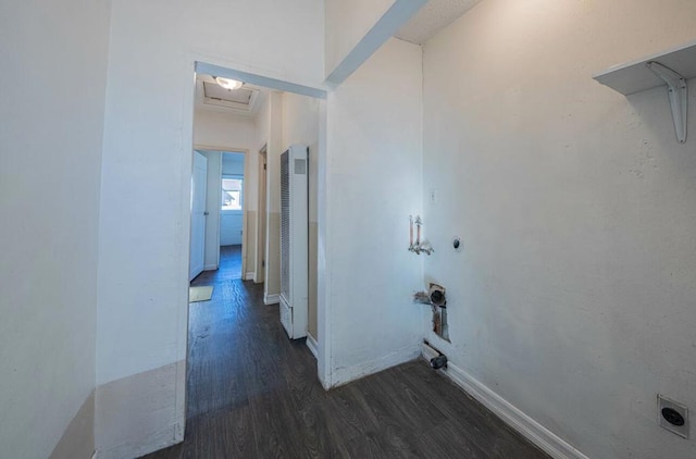 clothes washing area with dark wood-type flooring and hookup for a washing machine