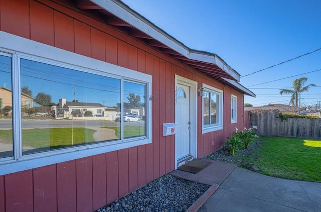 doorway to property with a lawn