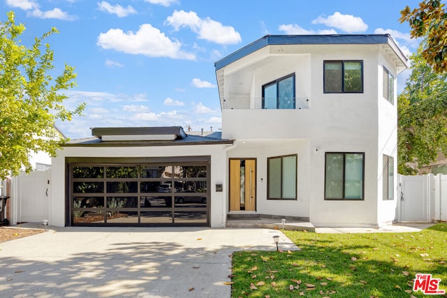 contemporary home with a front yard and a garage