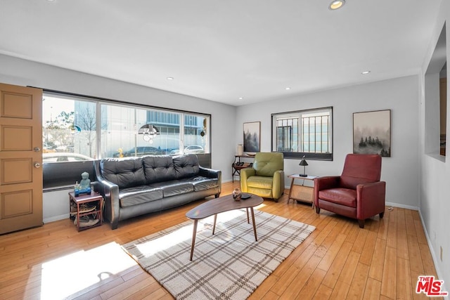 living room featuring a wealth of natural light and light hardwood / wood-style floors