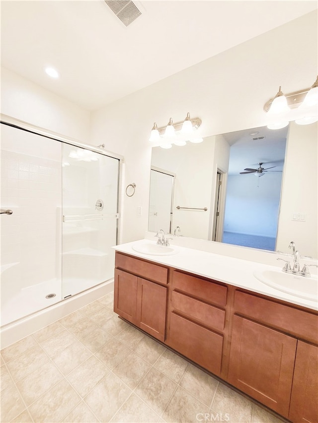 bathroom with vanity, ceiling fan, tile patterned floors, and a shower with door