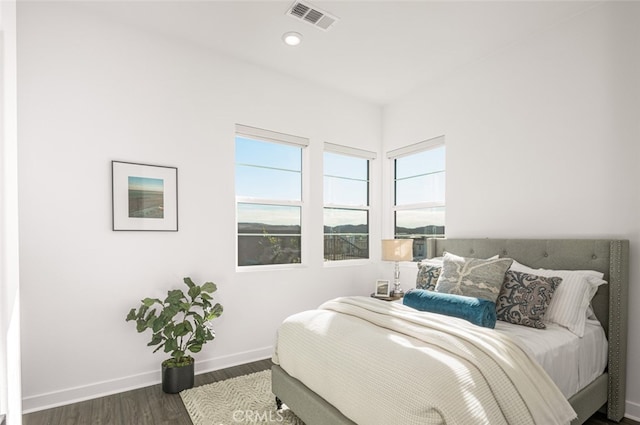 bedroom with dark hardwood / wood-style floors