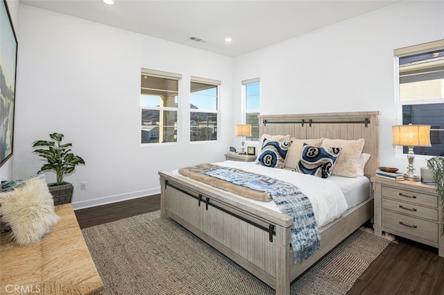 bedroom with dark hardwood / wood-style flooring