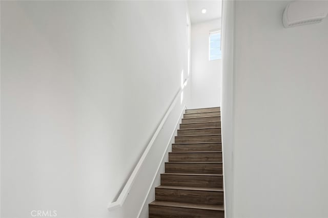 staircase featuring wood-type flooring