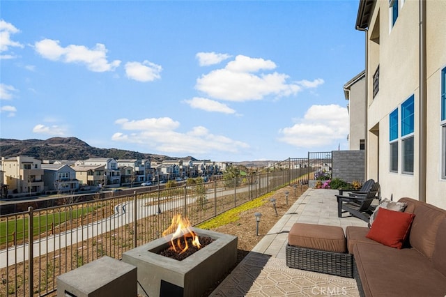 view of patio / terrace featuring a mountain view and a fire pit