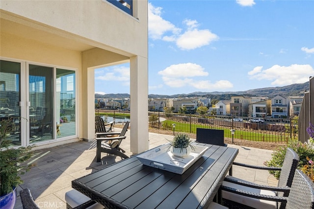 view of patio / terrace featuring a water and mountain view