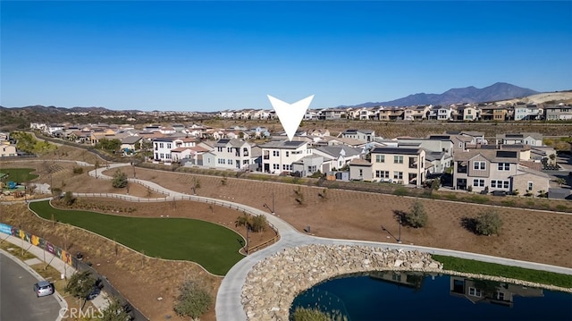 aerial view featuring a water and mountain view