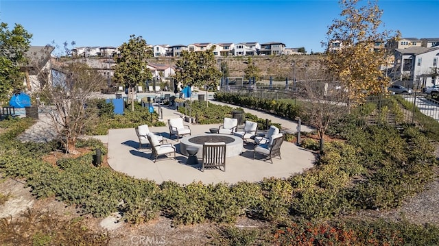 view of home's community with a patio area and a fire pit