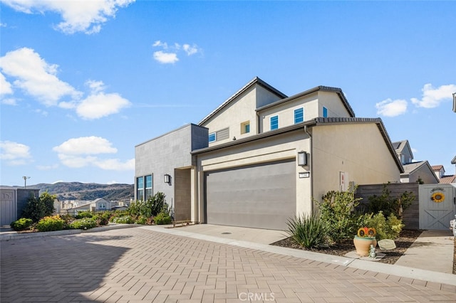 view of front of home with a mountain view and a garage