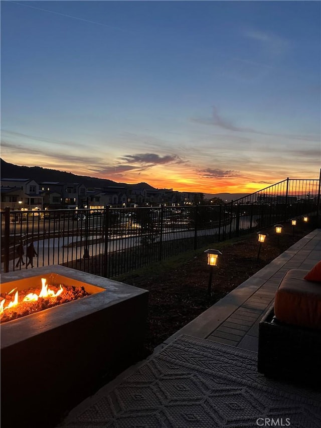 patio terrace at dusk featuring an outdoor fire pit