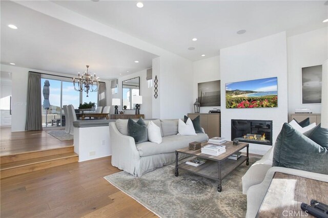 living room with a chandelier and hardwood / wood-style floors