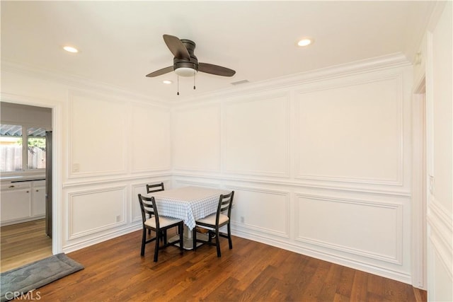 dining room with ceiling fan, dark hardwood / wood-style flooring, and crown molding