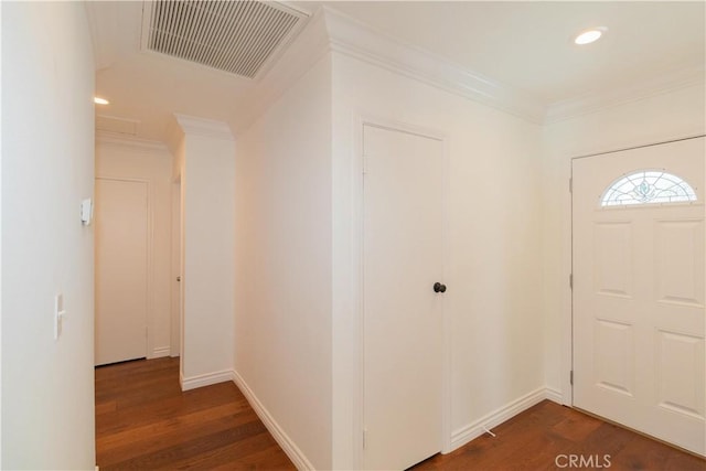 foyer with dark wood-type flooring and crown molding