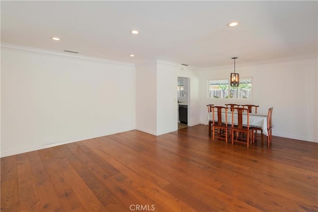 dining room featuring dark wood-type flooring and ornamental molding