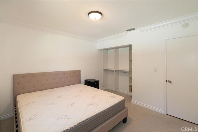 carpeted bedroom with a closet and ornamental molding