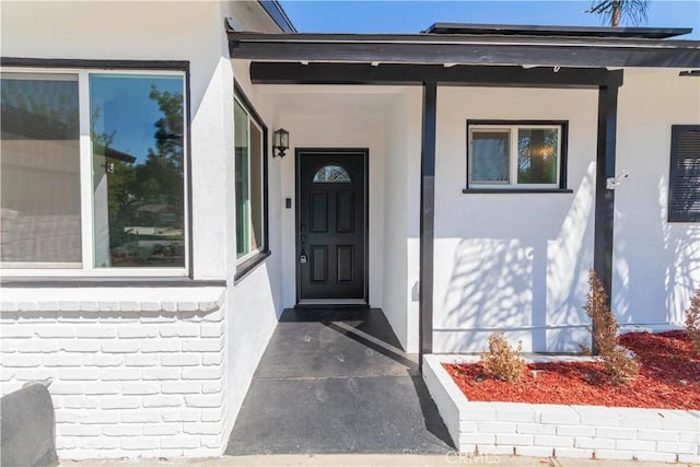 view of exterior entry with a porch