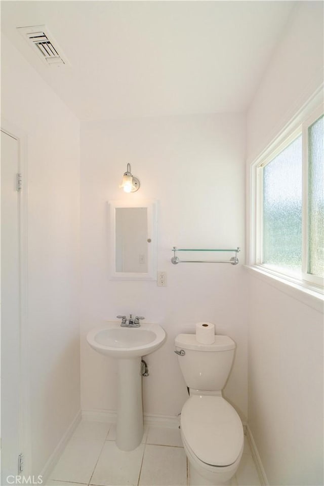 bathroom with toilet and tile patterned flooring