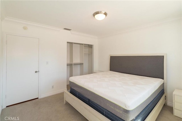 carpeted bedroom with a closet and crown molding