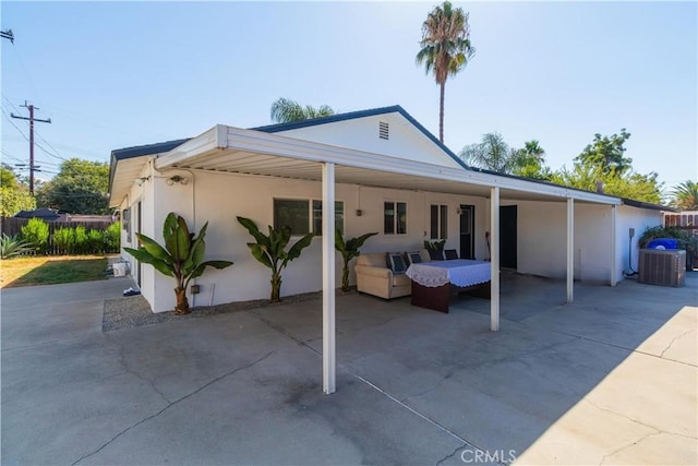 view of front facade with an outdoor living space and cooling unit