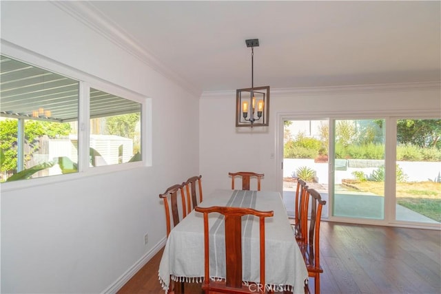 dining room featuring dark hardwood / wood-style floors, an inviting chandelier, and ornamental molding