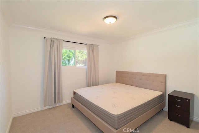 bedroom featuring crown molding and light carpet