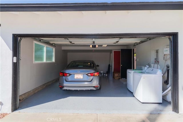 garage featuring a garage door opener and washing machine and clothes dryer