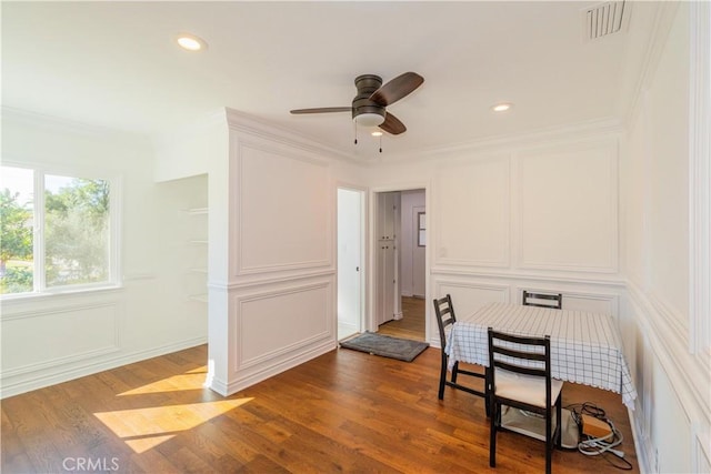 interior space with ceiling fan, ornamental molding, and hardwood / wood-style floors