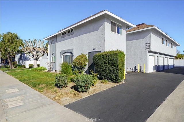 view of side of home with a yard and a garage