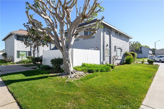 view of side of home featuring a yard