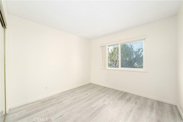 unfurnished room with light hardwood / wood-style floors