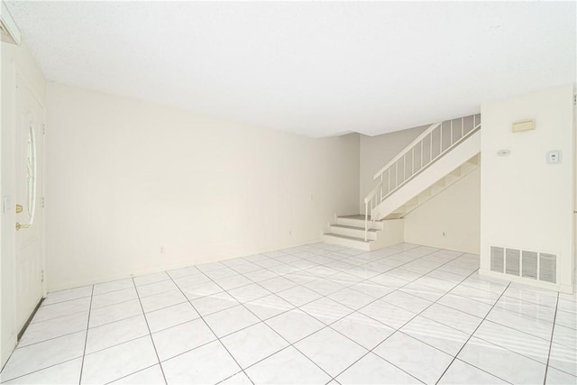 spare room featuring light tile patterned flooring