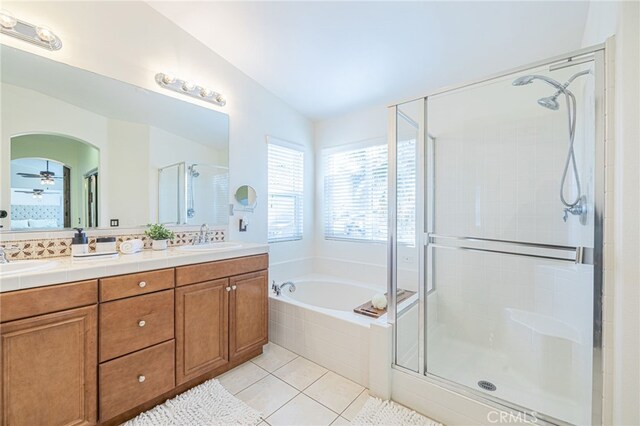 bathroom featuring lofted ceiling, tile patterned floors, tasteful backsplash, ceiling fan, and independent shower and bath