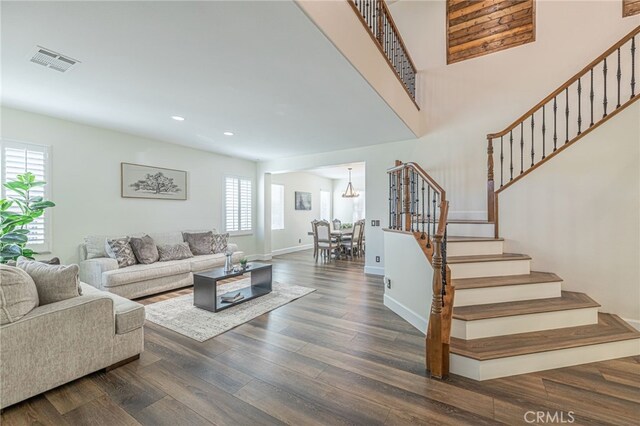 living room featuring dark hardwood / wood-style floors and a healthy amount of sunlight