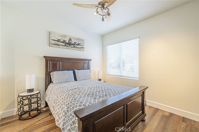 bedroom featuring ceiling fan and dark wood-type flooring