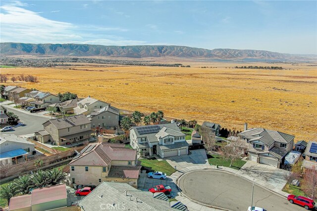 birds eye view of property with a mountain view